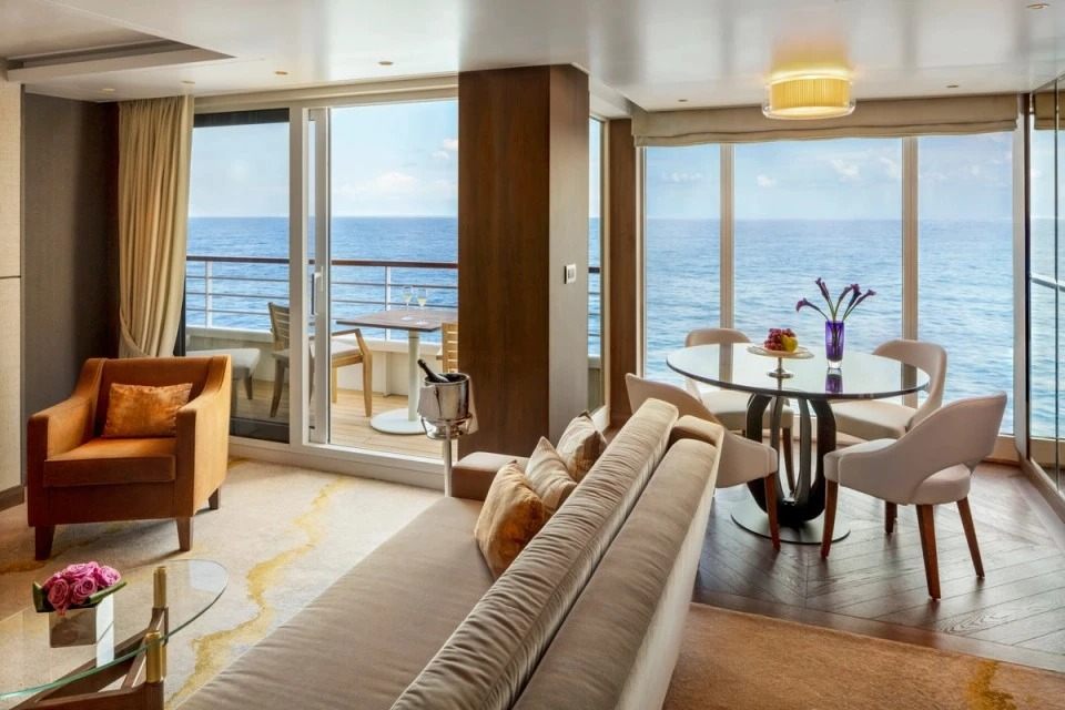Cruise suite lounge beside a balcony overlooking the sea